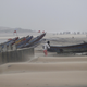 A fisherman walks near the anchored fishing boats in Gopalpur, Orissa, about 285 kilometers (178 miles) north east of Visakhapatnam.